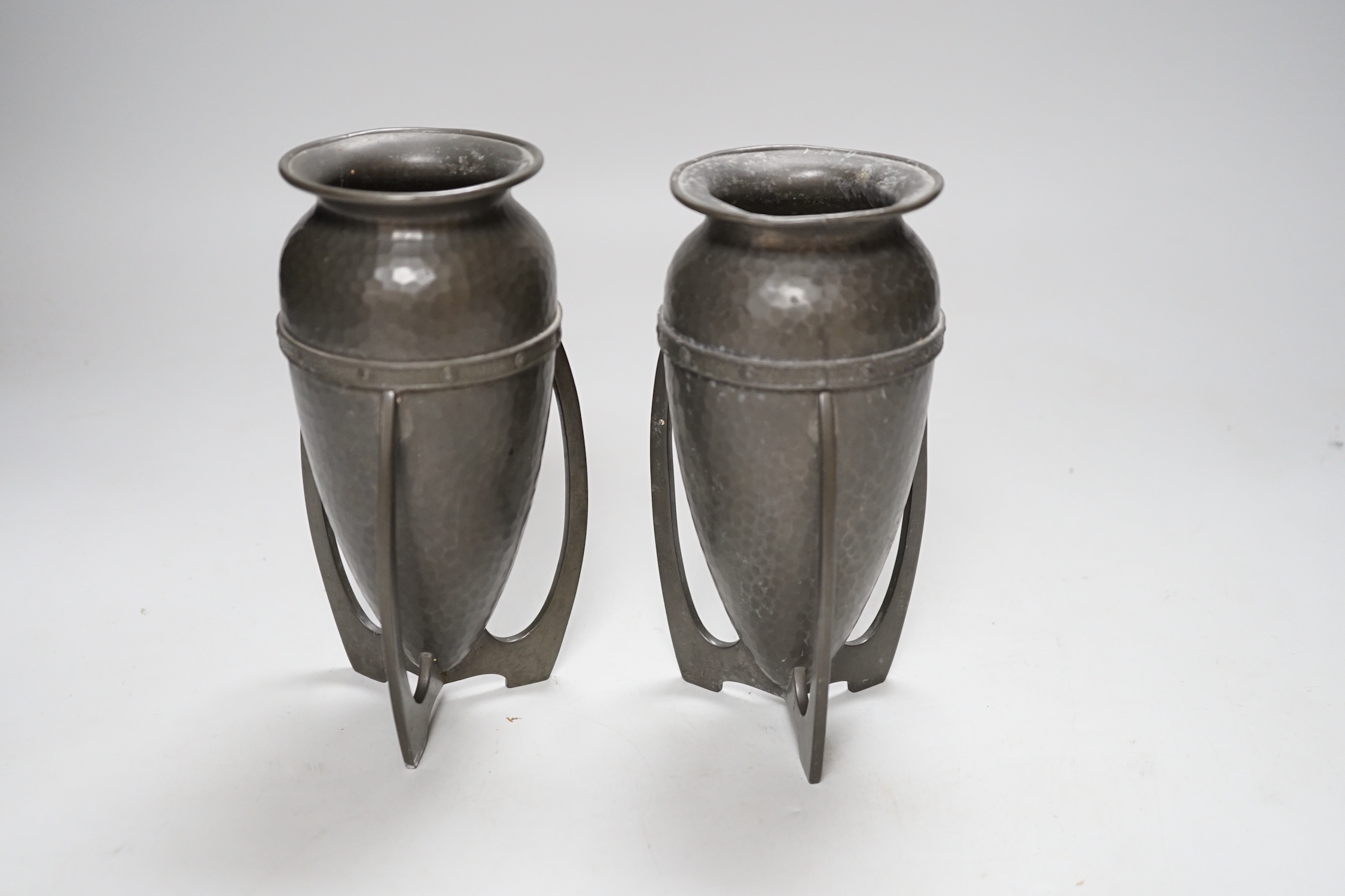 After Archibald Knox, pair of Art Nouveau style hammered pewter vases, 17cm high